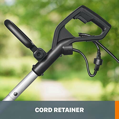 Handle of a corded electric trimmer with cord retainer