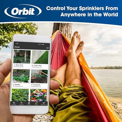 Person relaxing in hammock using smartphone app to control sprinklers.